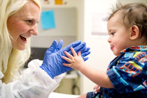 woman wearing gloves playing with child