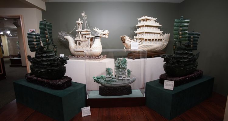 Five intricately carved jade dragon ships on display at the Belz Museum in Memphis.