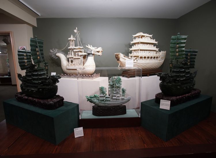 Five intricately carved jade dragon ships on display at the Belz Museum in Memphis.