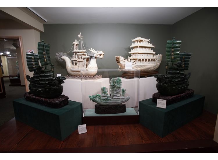 Five intricately carved jade dragon ships on display at the Belz Museum in Memphis.