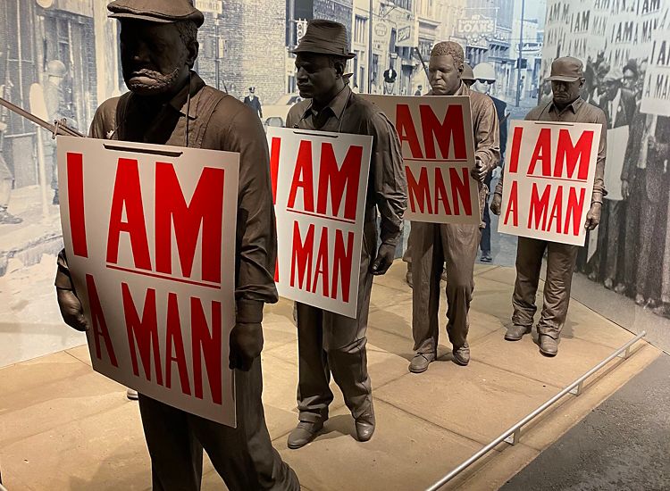 Sculpture of African American men, each holding signs that say "I AM A MAN" at the National Civil Rights Museum in Memphis.