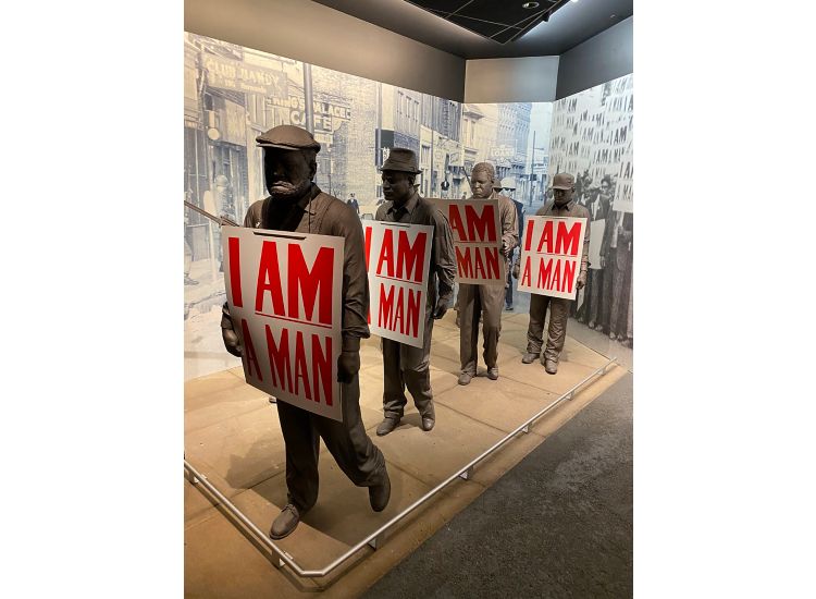 Sculpture of African American men, each holding signs that say "I AM A MAN" at the National Civil Rights Museum in Memphis.