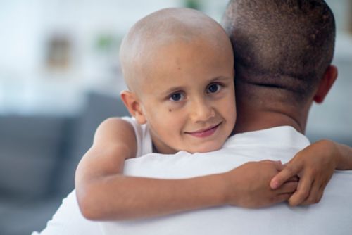 Girl with cancer hugging her father