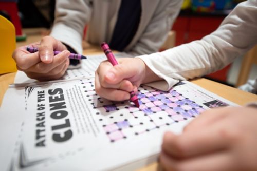 How you talk to your child about his or her cancer diagnosis is important. Stay calm when you talk to your child. In this image, a childhood cancer patient plays a game with her mom.