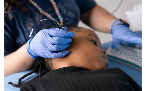 Nurse performing transcranial doppler on child