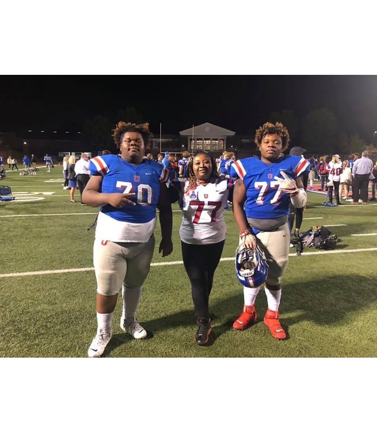 Teresa Franklin with two sons on football field