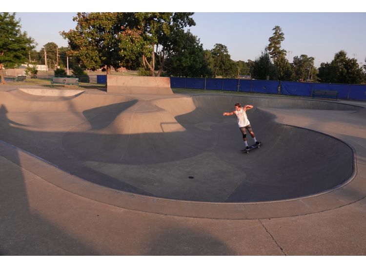 Tobey Skate Park with a skateboarder at golden hour sunset in Memphis.