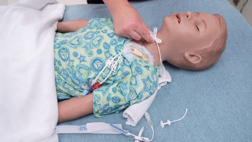 Proper hand placement of holding a trach