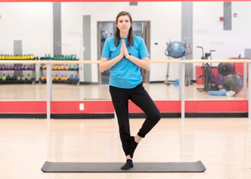 yoga instructor doing tree pose