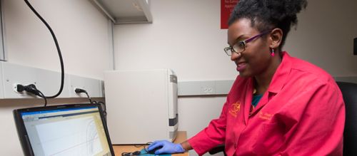 Jasmine Turner analyzes data from samples to determine the presence of influenza. She credits her mother for encouragement and inspiration to pursue a scientific career.