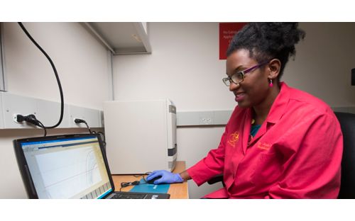 Jasmine Turner analyzes data from samples to determine the presence of influenza. She credits her mother for encouragement and inspiration to pursue a scientific career.