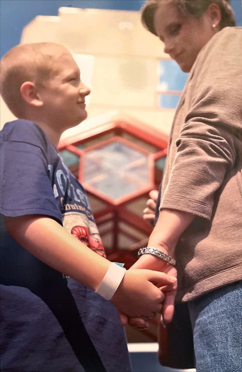 Kinchen as a child holding hands with his mother