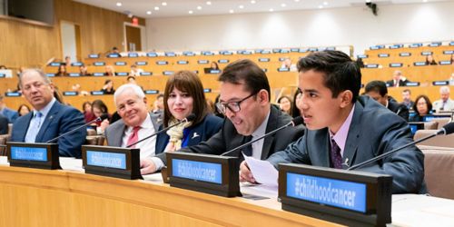 Young man speaking at UN, sitting next to four other people