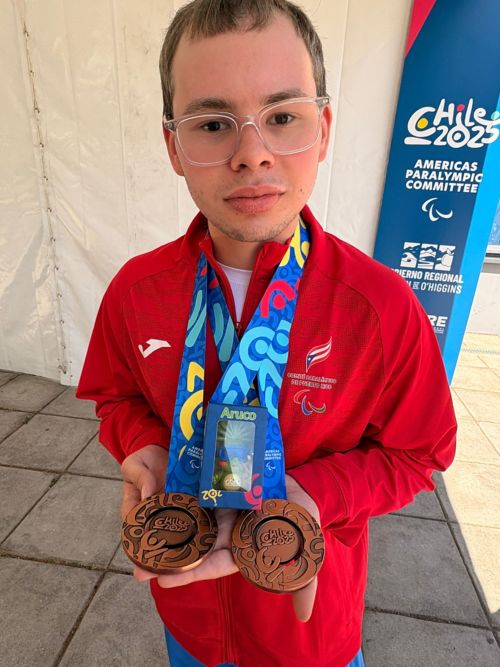 Yadiel holding his bronze medals