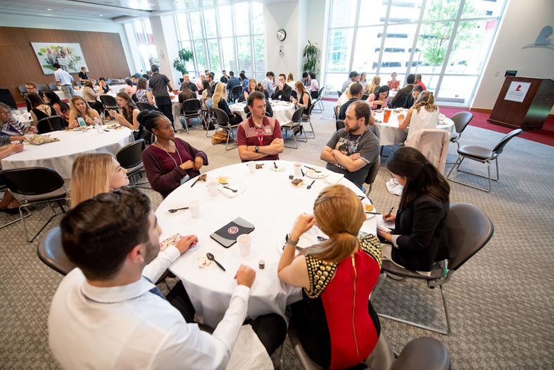 Participants having lunch with postdoctoral fellows.