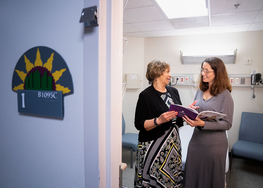 Two women conversing in hospital setting