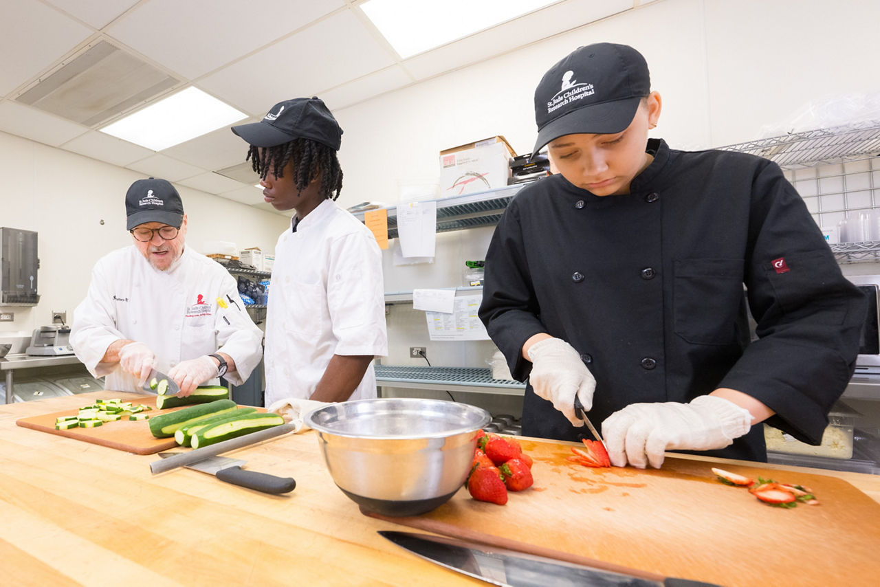 High school food interns working in kitchen