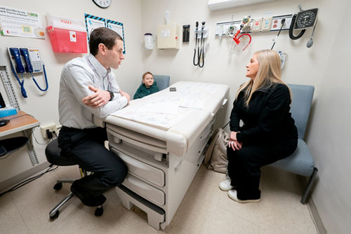 Seth Karol speaking with a mother and her son