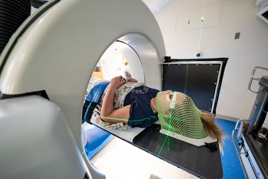 Female patient in proton therapy machine