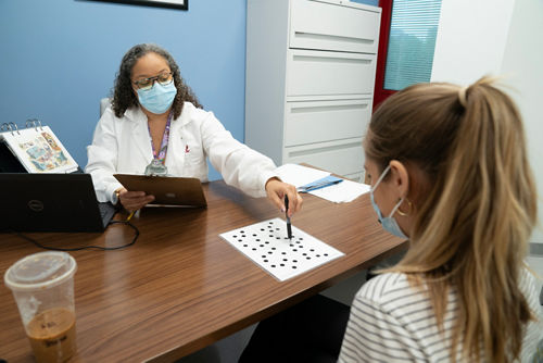 A patient doing a thinking skills exam