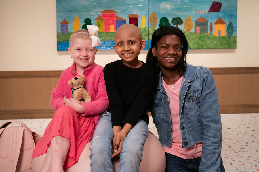 Three female patients pose in Family Commons