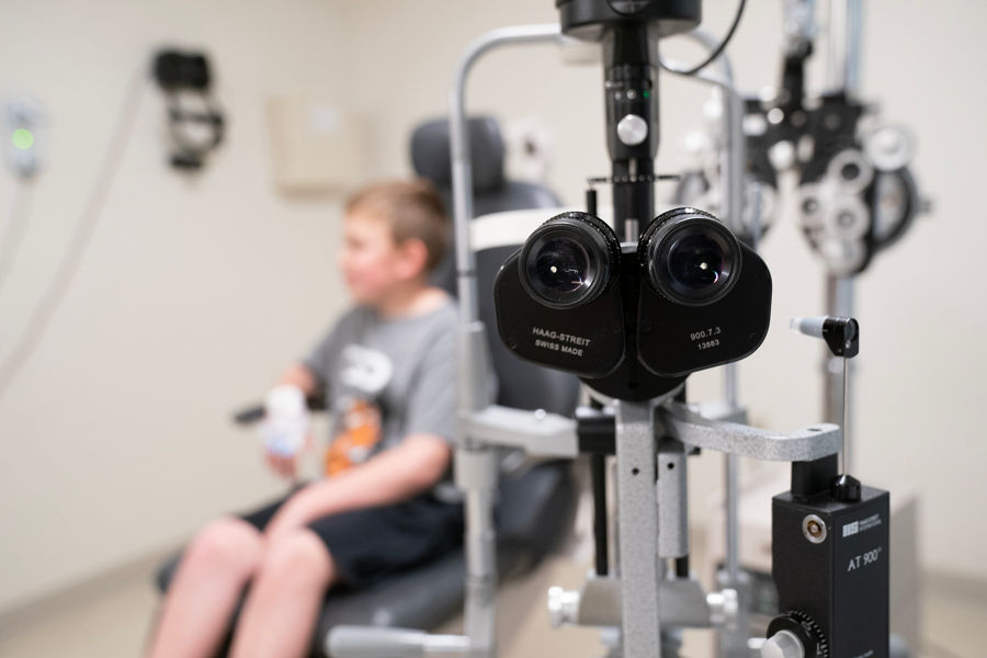 Eye exam room with child blurred in background
