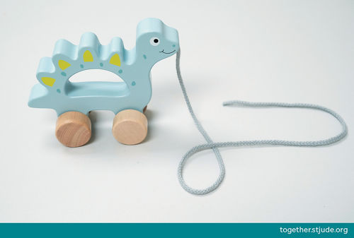 Un juguete de arrastre y empuje con forma de dinosaurio.