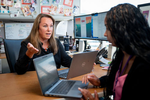 Sara Federico talking to a co-worker