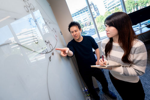 Man and woman working at whiteboard