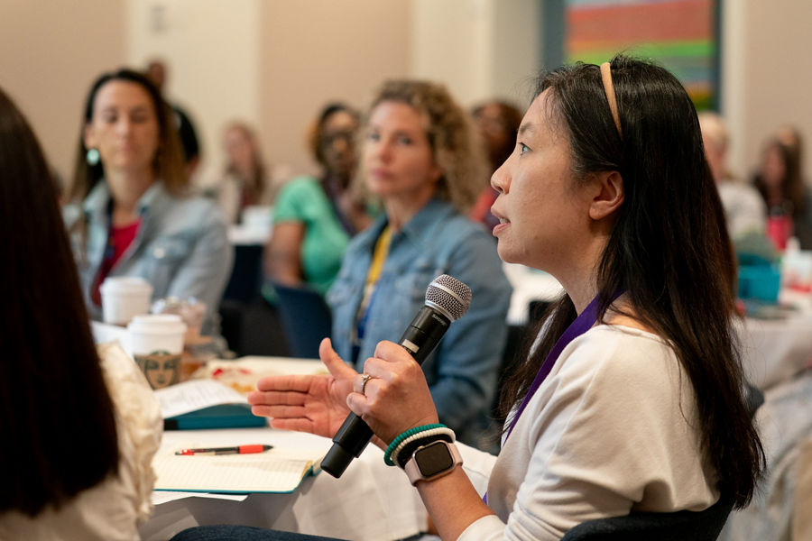 Woman speaking in microphone at event
