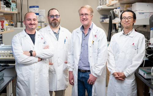a group of men in lab coats