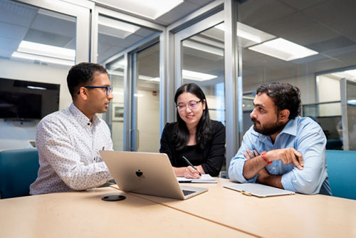 Three people sitting at a table
