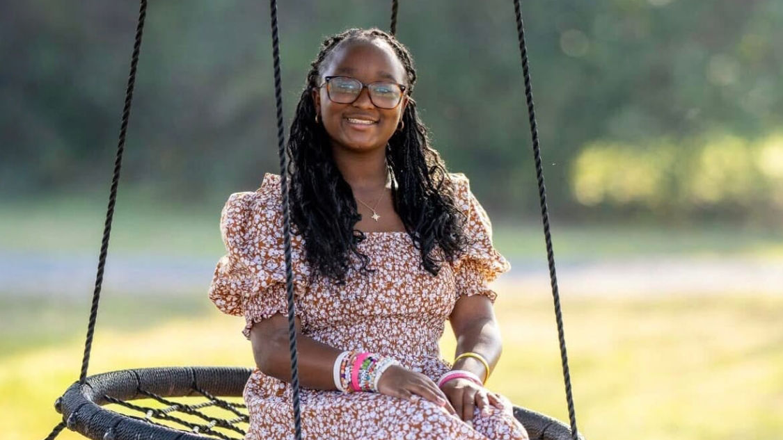 Krystalyn on a swing outside