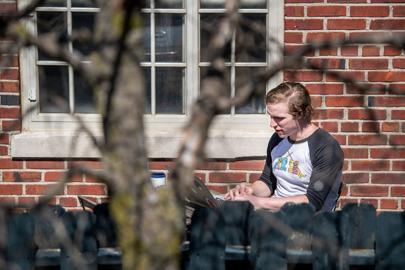 Man in casual clothes reading outdoors