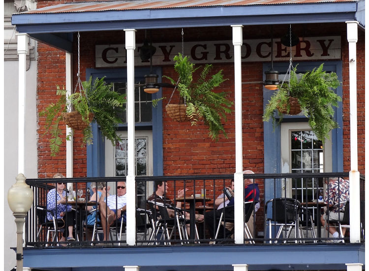 photo of people eating a meal on balcony