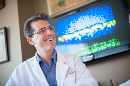 Michael Dyer smiles in front of a screen with scan results.