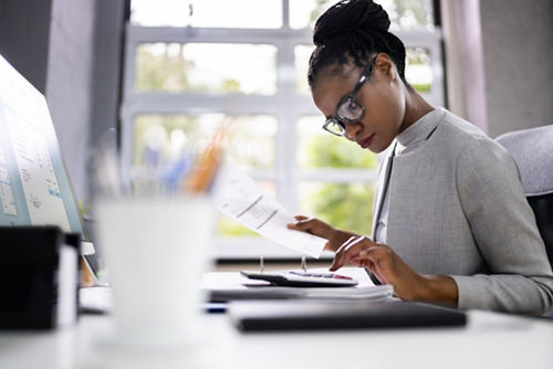 Woman looking at calculator