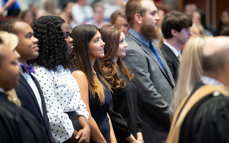 People standing in audience.
