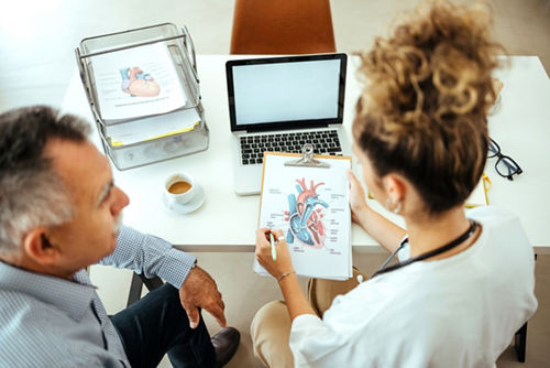 Patient and doctor look at cardiogram results