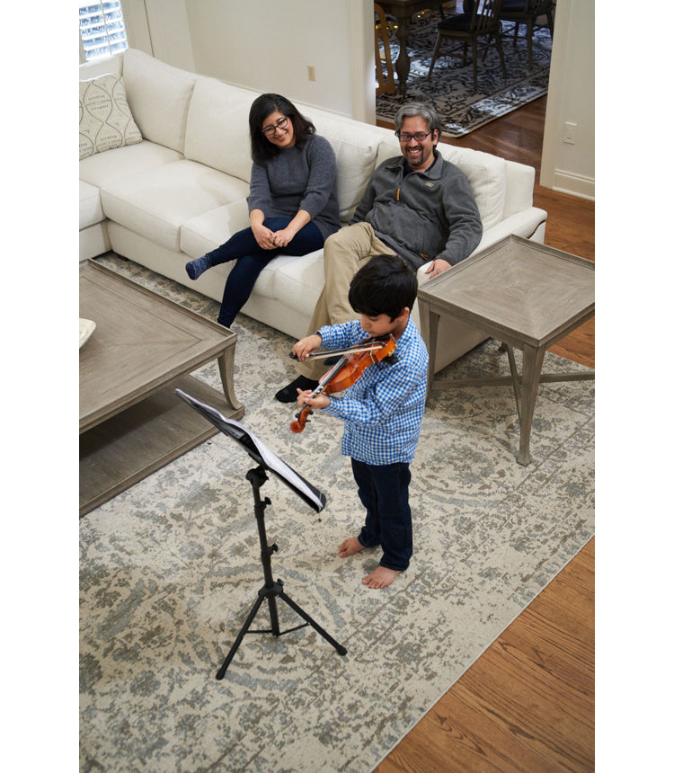 photo of Madan Babu and wife watching son play violin