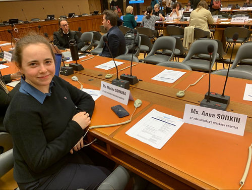 Marina Sonkina sitting at a table next to her nametag