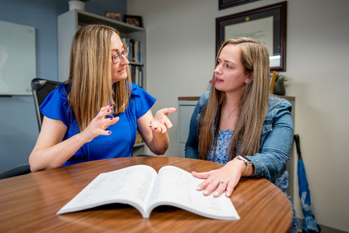 Two women talking. One is using gestures to make a point.
