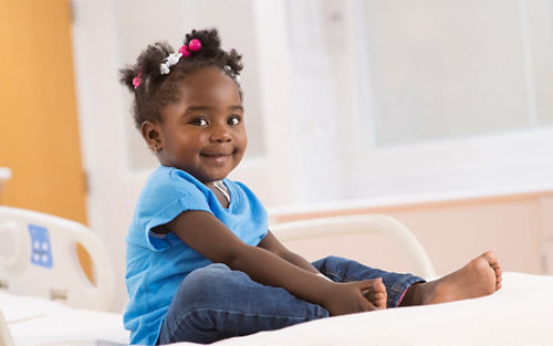 infant girl smiling at camera