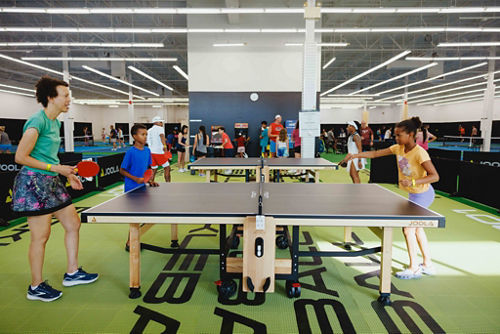 Mother and two children playing pingpong