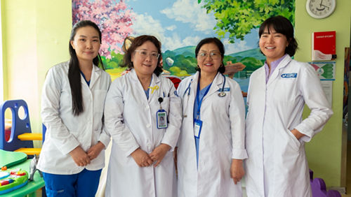 Four women in white coats