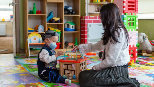 woman and child in playroom