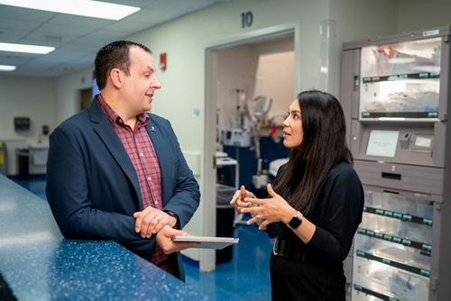 Two people talking at a counter
