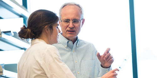 photo of Stephen Gottschalk, MD,  talking to colleague