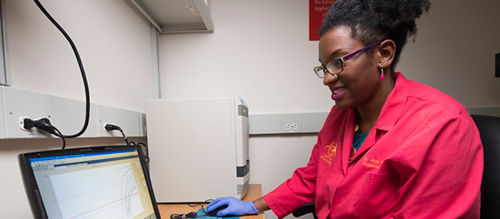 Jasmine Turner analyzes data from samples to determine the presence of influenza. She credits her mother for encouragement and inspiration to pursue a scientific career.