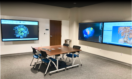 Room full of computer monitors with table in middle of the floor
